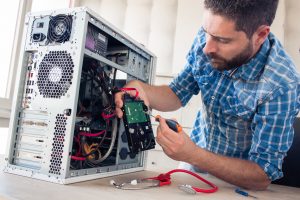 Engineer repairs computer's hard drive